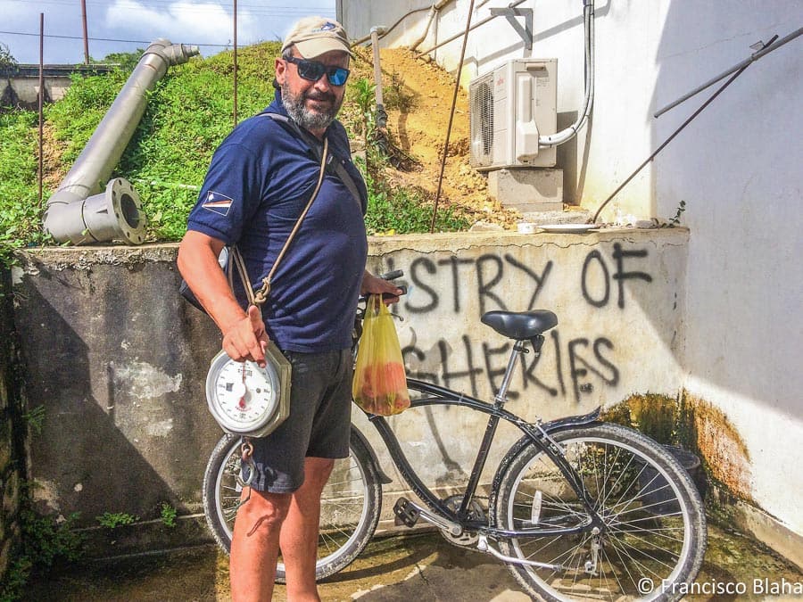 Francisco Blaha stands outside a fisheries office in the Pacific, with a bicycle for transport and manual scales to work with (Photo: Francisco Blaha)