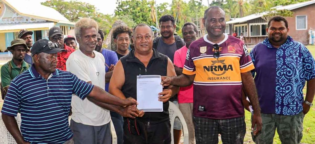 Group of men at formal signing up of Russell Islands Fisheries Association, Solomon Islands. In the photo are unidentified members of the association and Savo-Russells MP Dickson Mua and Central Islands Province Premier Stanley Manetiva. Photo: Solomon Islands Government Communications Unit.