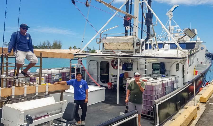 Three men on deck of research vessel Gutsy Lady 4 being prepared at Kewalo Basin, Honolulu, for the tuna tagging cruise in the central Pacific. Photo SPC.