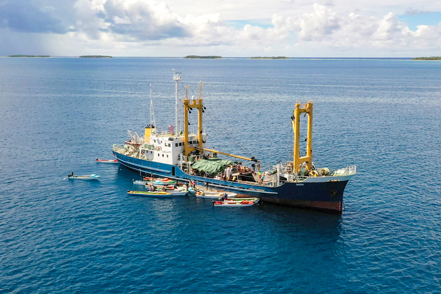 MV Onogou on a trip to Ontong Java. Alongside it are the small outboard speedboats that locals use for transport. Photo: Iggy Pacanowski.