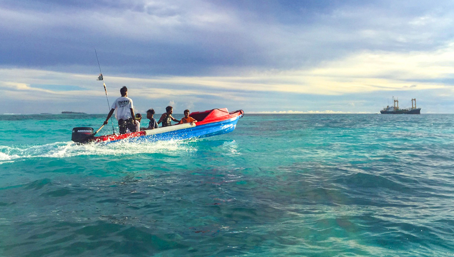 Small speedboat moving through shallow atoll waters. Small outboards like this are the only means of transport between the islands of Ontong Java. Photo: Iggy Pacanowski.