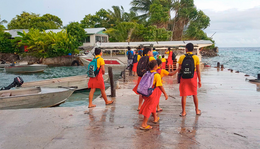 Students of Tialeniu School make their way to the school shuttle to take them across the lagoon to Fenuafala where the school is located. Photo: Litia Maiava/Te Mana.