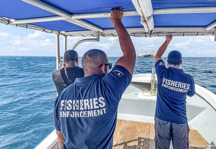 Marshall Islands fisheries officers Beau Bigler and Melvin Silk head across Majuro Lagoon in February 2020 to board and inspect an arriving vessel. They use analysis of pre-arrival intelligence before they will authorise a ship to use the port. Photo: Francisco Blaha.