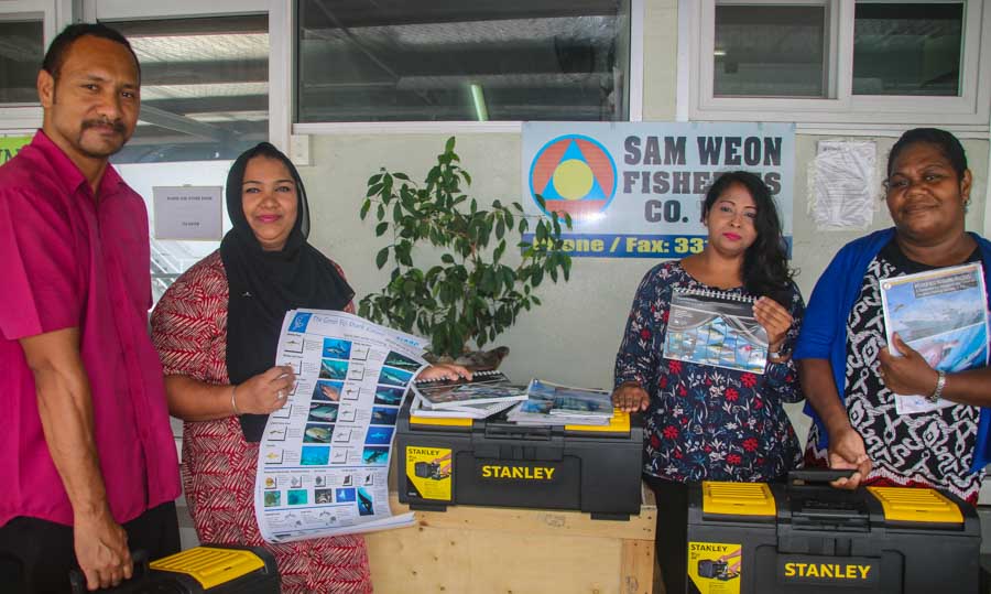 Sam Weon and the staff of Green Tuna Fisheries receive bycatch mitigation toolkits and awareness materials for fishing vessels. Photo: WWF-Pacific/Ravai Vafo’ou.