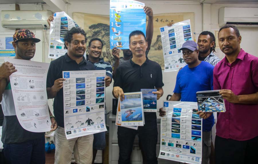 Sunshine Fisheries crew with their General Manager, Darren Zhang, receive their bycatch awareness materials for fishing vessels. Photo: WWF-Pacific/Ravai Vafo'ou.